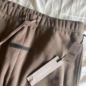Selling fear of god essentials M sweatpants in the color harvest. NWT